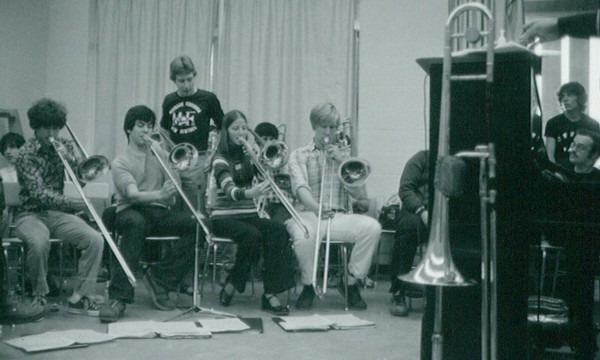 Nick Lane rehearses the high school trombone section. That night they will "sit in" with Maynard and the band.